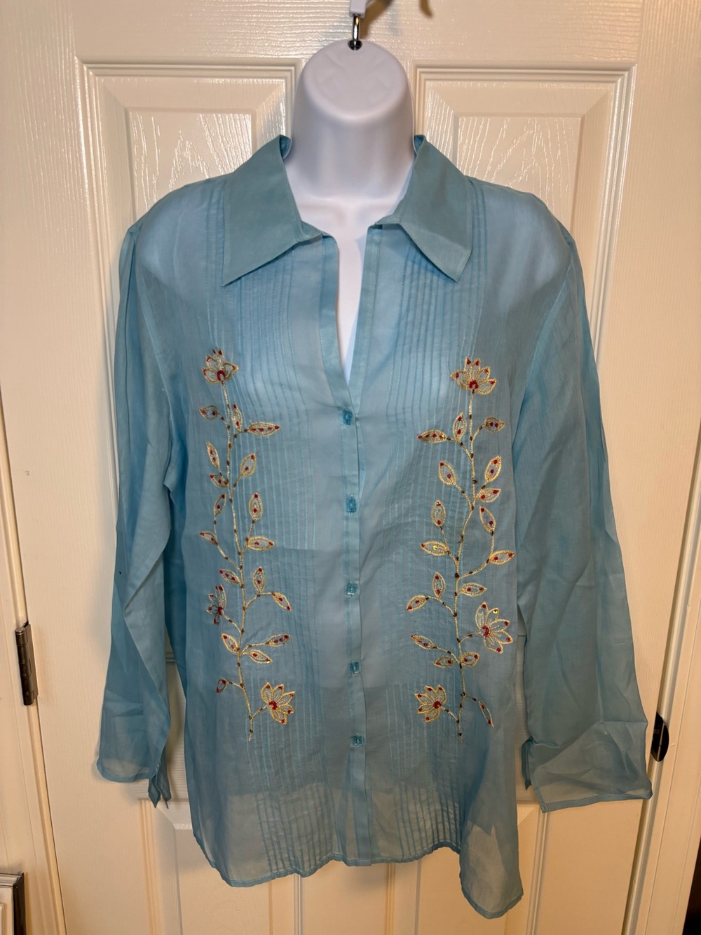 Blue sheer blouse with floral embroidery and beading by JH Collectibles. Size L